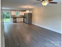 Open concept living room and kitchen with stainless appliances and wood-look flooring at 307 Messner St, Salisbury, NC 28144
