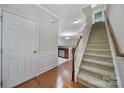 Bright foyer with hardwood floors, staircase, and view of the kitchen at 321 Rose Garden Ct, Rock Hill, SC 29732