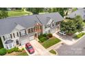 Overhead view of townhouses with manicured lawns, driveways and green landscape with trees at 4208 Carl Parmer Dr, Harrisburg, NC 28075