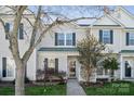 Traditional two-story home with neutral siding, dark shutters, covered entryway, and professional landscaping at 4211 Center Place Dr, Harrisburg, NC 28075