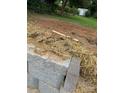 Close up of a retaining wall, straw, and fill dirt on a homesite at 1524 Conestoga Xing, Catawba, NC 28609