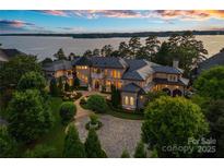 Luxury lakefront estate features manicured landscaping and stunning architectural details at 18019 Harbor Light Blvd, Cornelius, NC 28031