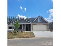 Charming single Gathering home showcasing stone accents, a two-car garage, and lush green lawn at 835 A Wynnshire Dr # 53, Hickory, NC 28601