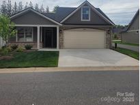Charming single-story home with stone accents, a two-car garage, and a well-maintained lawn at 835 A Wynnshire Dr # 53, Hickory, NC 28601