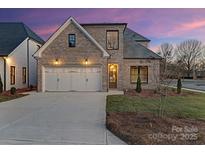Charming brick home featuring an attached two-car garage and well-maintained landscaping at 8159 Fairview Rd, Charlotte, NC 28226