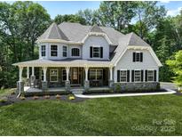 Stunning two-story home with a stone-accented facade and inviting front porch at 843 Lake Forest Dr # Devonshire, Belmont, NC 28012
