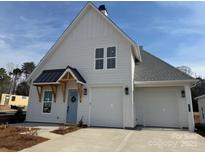 Charming new construction home with a light blue door, two-car garage, and modern farmhouse details at 4314 Morning Mist Dr # 15, Sherrills Ford, NC 28673