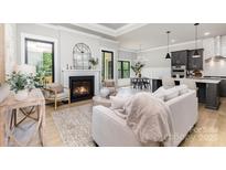 Open living room with fireplace, wood floors, and seamlessly flowing into kitchen and dining areas at 179 Heartland Dr # 8, Rock Hill, SC 29732