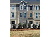 Charming townhome exterior featuring a mix of siding and brick accents, complimented by a neatly landscaped front yard at 4223 S New Hope Rd # 8, Cramerton, NC 28032