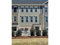 New townhouse with gray siding, brick accents, and a charming white picket fence at 4225 S New Hope Rd # 9, Cramerton, NC 28032
