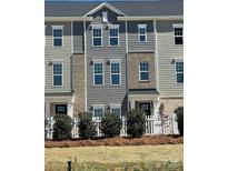 Charming townhome featuring gray siding, brick accents, and manicured landscaping in a friendly neighborhood at 4227 S New Hope Rd # 10, Cramerton, NC 28032