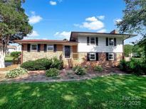 Charming two-story home with brick facade, black shutters, and manicured lawn at 1006 Wilson Blvd, Dallas, NC 28034