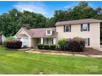 Charming home featuring a landscaped yard, neutral siding, and classic architectural details at 7210 Morningdew Ct, Denver, NC 28037