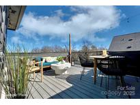 Relaxing rooftop deck with seating area and city views at 1013 North End Dr # 26, Charlotte, NC 28206