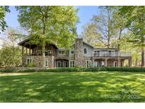 Stunning stone home with covered balcony and beautiful lawn at 501 Nivens Cove Rd, Mount Holly, NC 28120