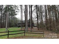 Secluded home with rustic fence and wooded surroundings at 12505 Old Beatty Ford Rd, Rockwell, NC 28138