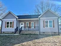 Cute gray house with a black railing and wooden shutters at 325 Jordan Ave, Spencer, NC 28159