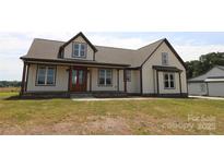Inviting two-story home featuring a covered front porch, neutral siding, and contrasting dark trim, creating a charming curb appeal at 1405 Coppergate Dr, Salisbury, NC 28147