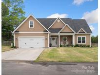 Tan house with white trim, two-car garage, and a front porch at 2165 Smith Rd # 9, Clover, SC 29710