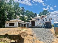 New construction home featuring a unique roof design and high-quality Tyvek weather-resistant barrier at 8022 Litaker Manor Ct, Charlotte, NC 28270