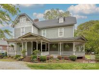 Two-story house with a wrap-around porch and landscaped yard at 404 W Kerr St, Salisbury, NC 28144