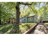 Gray craftsman home with a large tree and landscaped yard at 423 W Bell St, Statesville, NC 28677