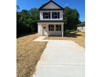 Charming two-story home featuring black shutters, a concrete driveway, and a welcoming front porch at 814 W Raleigh W Ave, Statesville, NC 28677