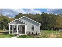 Charming home featuring stone accents, a cozy porch, and landscaped front yard at 2668 Meadow St, Gastonia, NC 28056