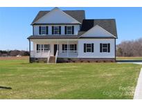 Two story house featuring white siding, black shutters, and a grassy lawn at 1145 Philbeck Rd # 11, York, SC 29745