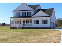 Two-story farmhouse with white siding, black accents, and a front porch at 1187 Philbeck Rd # 13, York, SC 29745