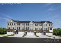 Modern townhouses with attached garages and well-manicured lawns at 452 Moondance Dr, Gastonia, NC 28054