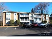 Brick condo building with balconies and ample parking at 1645 Arlyn Cir # J, Charlotte, NC 28213