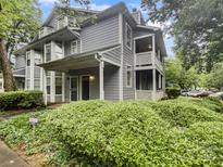 Charming home featuring a covered front porch and two-story balcony with well-maintained landscaping at 6003 Treetop Ct, Charlotte, NC 28212