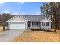 Charming single-story home with attached garage, gray siding, and a well-manicured lawn on a sunny day at 6122 Lowder Rd, Salisbury, NC 28147