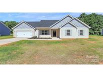 Charming single-story home featuring a landscaped front yard and attached garage, perfect for comfortable living at 6154 Lowder Rd, Salisbury, NC 28147
