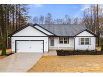 Charming single-story home with a well-maintained yard and attached garage in a quiet neighborhood at 6160 Lowder Rd, Salisbury, NC 28147