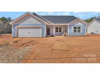Charming single-story home with blue siding, garage, and covered front entry showcasing a modern, cozy design at 6160 Lowder Rd, Salisbury, NC 28147