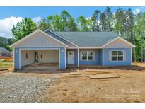 Charming single-story home featuring light blue siding and an attached, open single-car garage at 6133 Long Branch Rd, Salisbury, NC 28147