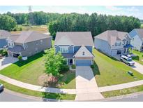 Beautiful two-story home with manicured lawn, two-car garage, and attractive curb appeal at 3023 Spinner Ct, Denver, NC 28037