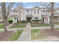 Charming townhome showcasing landscaped front yard and inviting entryway at 17615 Trolley Crossing Way, Cornelius, NC 28031