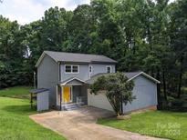 Gray two-story house with attached garage and landscaped yard at 4939 Lailwood Cir, Charlotte, NC 28227