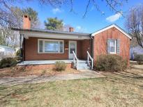 Charming brick home with a cozy front porch and well-maintained lawn at 553 Georgia Ave, Statesville, NC 28677