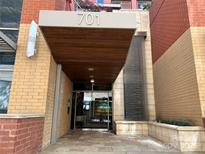 Modern building entrance with water feature and covered entryway at 701 Royal Ct # 309, Charlotte, NC 28202