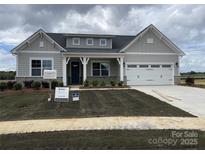 Charming single Gathering home with a two-car garage, beautiful lawn, and craftsman-style columns at 4679 Hopsack Dr # Cal0108, Indian Trail, NC 28079