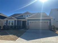 Two-story craftsman style home with neutral siding and a two-car garage at 2533 Crimson N Way, Monroe, NC 28112