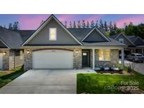 Charming home exterior showcasing a stone facade, attached garage, and well-manicured lawn at 833 B Wynnshire Dr # 55, Hickory, NC 28601
