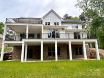 New construction home featuring a walkout basement, a multi-level deck, and a well-manicured lawn at 416 Plantation Way, Mount Gilead, NC 27306