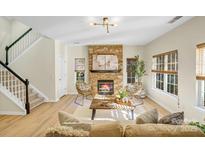 Inviting living room showcasing a stone fireplace and a staircase leading to the second floor at 2907 Meherrin Ct, Waxhaw, NC 28173