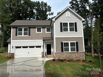 Charming two-story home with a well-manicured lawn and an attached two-car garage at 109 Florence Rd, Statesville, NC 28625