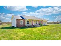 Charming single-story home boasts a well-manicured lawn and inviting front porch at 927 Happy Plains Rd, Taylorsville, NC 28681